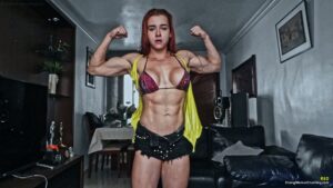 Red rips shirts from her muscular body