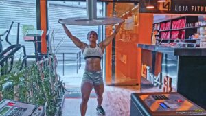 Tatiana she does biceps curls and lifts tables overhead