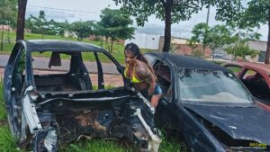 Gil Cunha uses a scrap car to pump her muscles