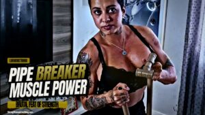 Luh Monstrinha breaks a plastic pipe to pump her muscles