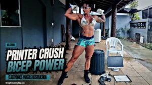 Gil Cunha shows her strength by destroying a printer with her immense biceps