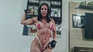 Fabi crushes a tray pan into a rumble with her muscular arms and strength