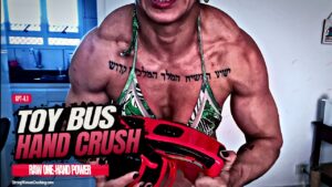 Sassenach crushes a toy bus with her massive muscles