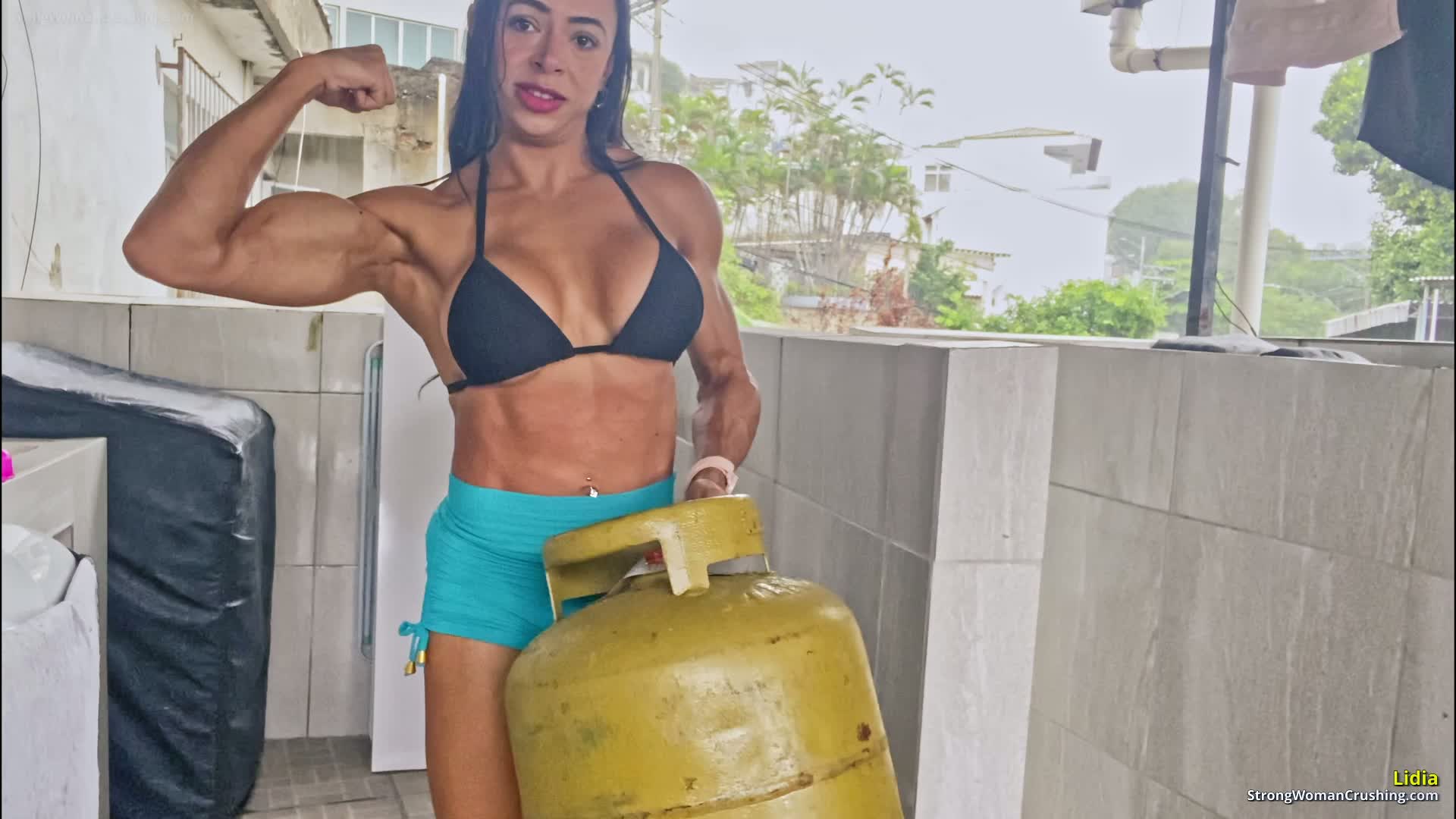 Lidia pumps her muscles with a gas cylinder