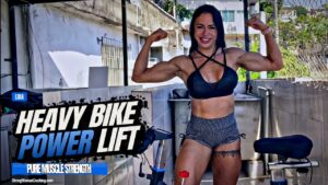 Lidia lifts a heavy ergometric bike