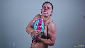 Sassenach crushes the helmet between her powerful chest muscles